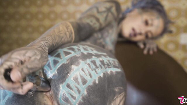 Tattooed teen with purple hair gropes cock on fuck machine