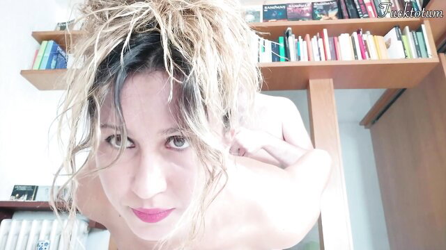 Blonde amateur first-timer nude closeup, messy bun hair, bookshelves background