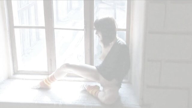 Slim Asian girl in white leggings sits by window, solo tease