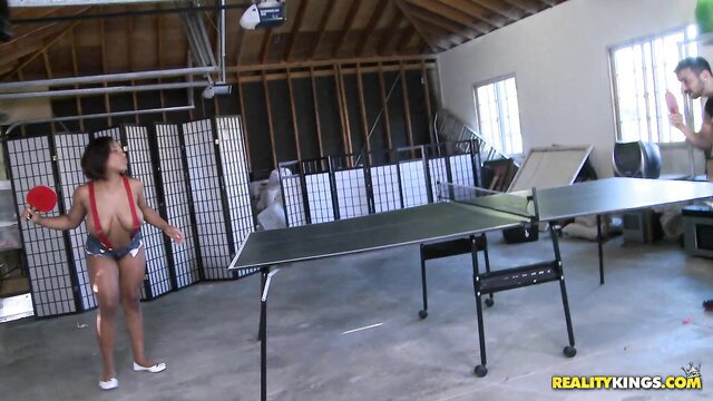 Busty black Yasmine Loven in red slingshot bikini playing ping pong