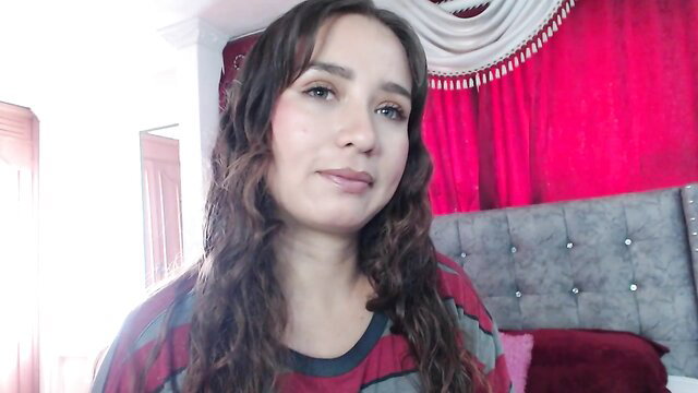 Iris Conner curvy Latina amateur webcam girl smiling in colorful striped top