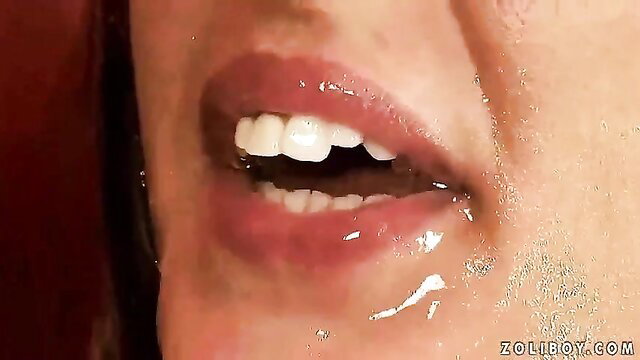 Closeup of sexy redhead's glossy lips dripping with cum and piss