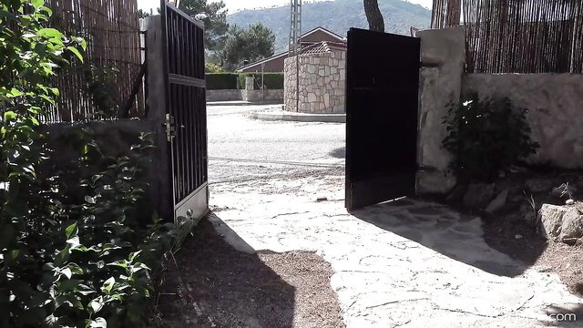 Open gate to Karups outdoor courtyard with greenery and stone walls