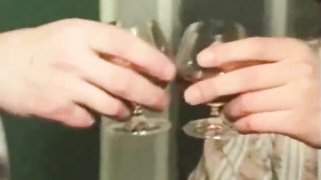 Classic Tabu Film couple toasting with wine glasses, intimate tease