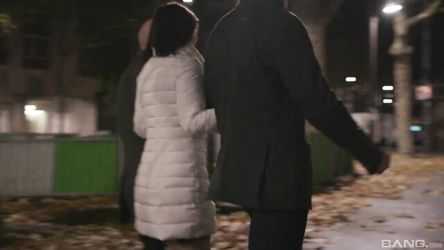 Alysa Gap in white puffer jacket walks at night with man on street