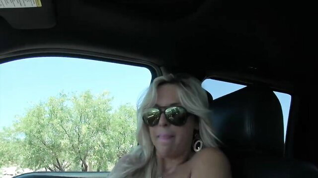 Busty blonde MILF Sandra Otterson in car sunglasses