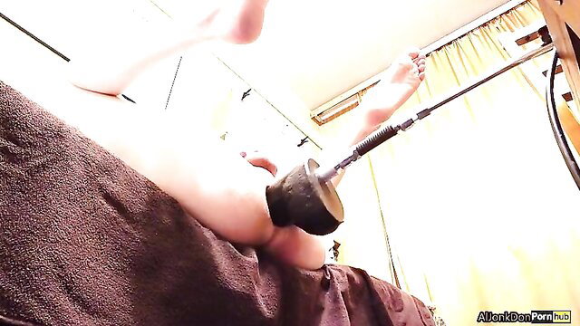 Slim girl polishes ass with huge black dildo closeup