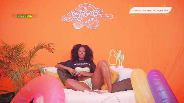 Curvy black brunette in lingerie spreads legs, wet pussy lust in orange room