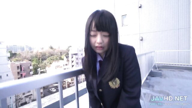Japanese schoolgirl in uniform on rooftop, shy expression, long black hair