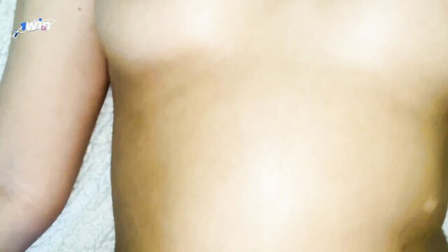 Tanned Asian teen girl topless with blue bandage on arm, seductive pose