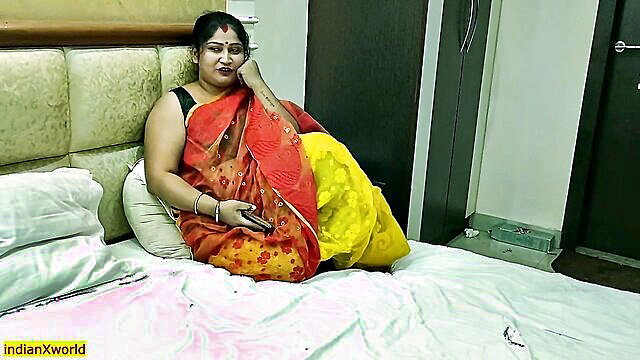 Desi middle-aged Indian wife in red saree on bed, hot erotic pose