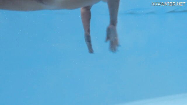 Emily Rossi nude underwater, arm and hand visible in clear pool