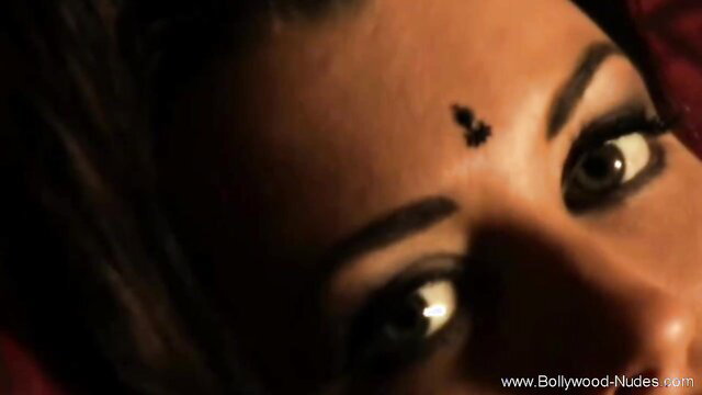 Closeup of seductive Indian Bollywood girl's eyes and bindi nude scene