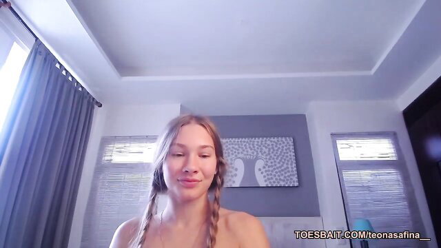 Young blonde babe with pigtails smiles nude, naughty booty tease