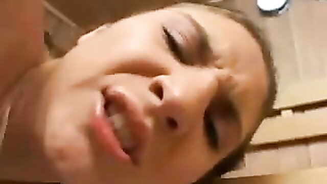 Brunette with furrowed brow in intense sauna fuck closeup