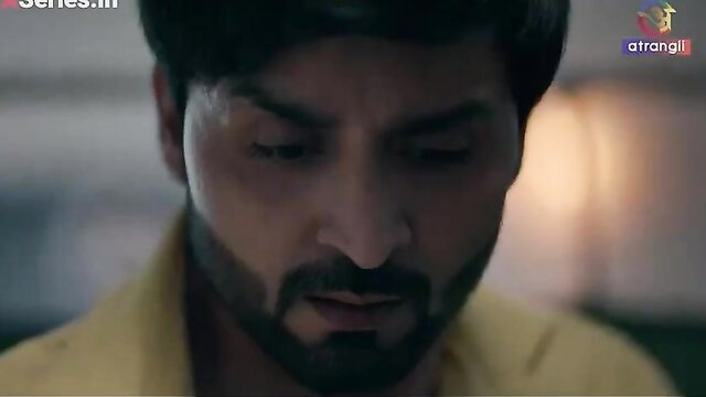 Handsome Indian man in yellow shirt closeup, intense gaze in adult video thumbnail