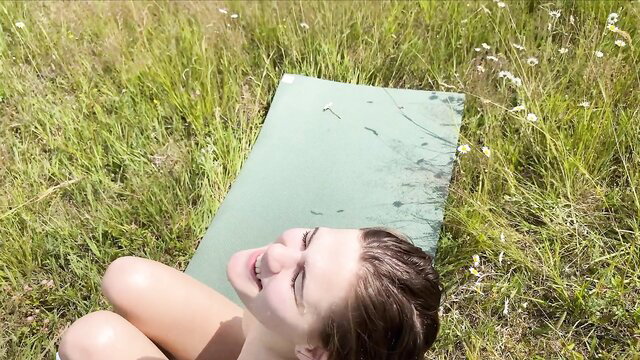Smiling brunette amateur babe nude on yoga mat in sunny field