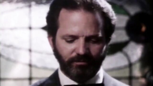 Lisa Deleeuw in suit gazing intensely, Southern Traditional Brothel 1982