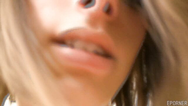 Closeup of skinny blonde girl's glossy lips and nose on Sybian