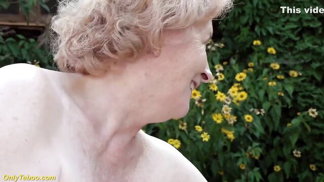 Mature blonde granny nude profile smiling in garden outdoor