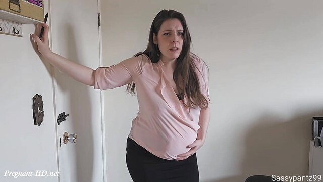 Pregnant brunette teacher in pink blouse and skirt by door, XL Girls