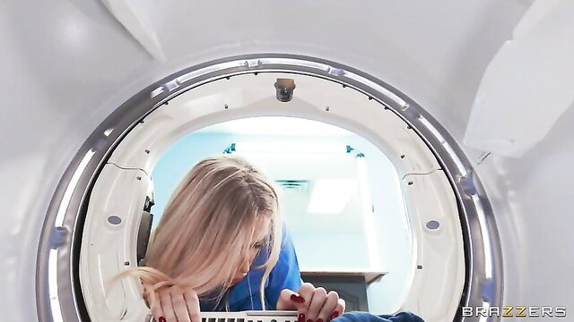 Blonde nurse leaning into MRI machine in tight scrubs, naughty hospital tease