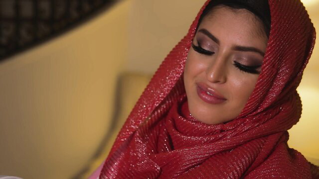 Sophia Leone seductive closeup in red hijab, glossy lips and smoky eyes