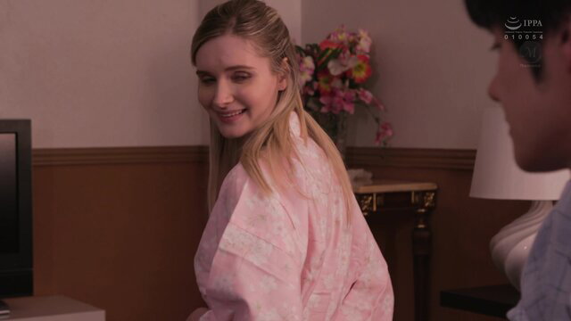Blonde in pink robe smiles at man in JAV father-in-law seduction scene