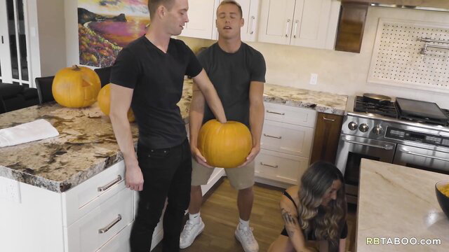 Justin Matthews & Trevor Ridge hold pumpkins with Asian girl under counter, taboo tease
