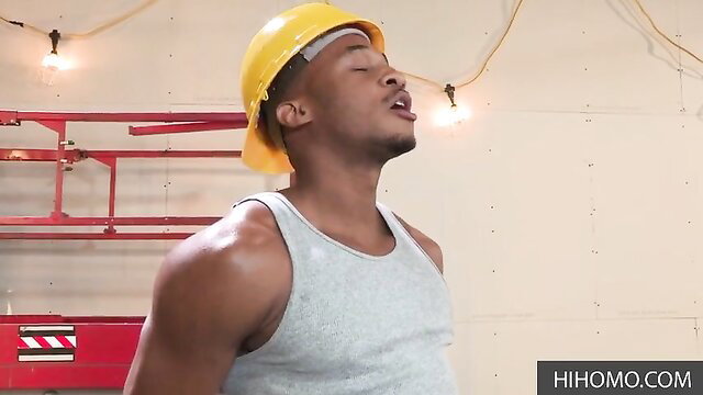 Hot black construction worker in tank top and hard hat tilts head back seductively