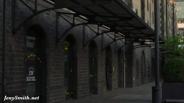 Shameless harlot in front of Basel shop under dark awning