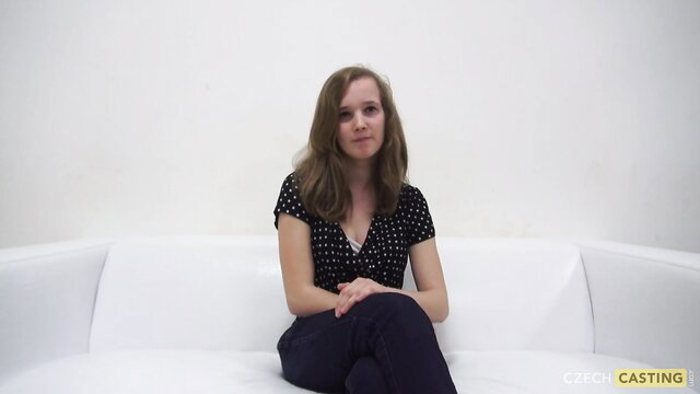 Andrea sits clothed on couch in Czech casting, pretty brunette amateur