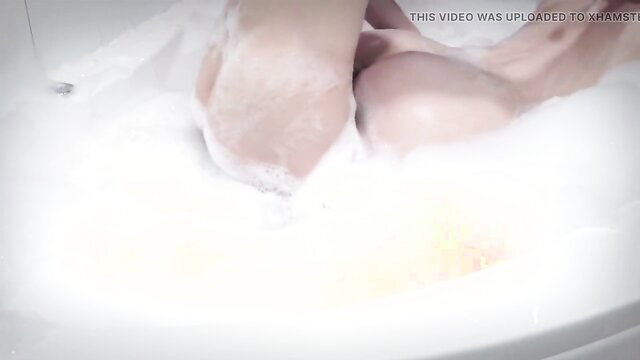 Busty woman naked in bubbly hot tub bath, teasing wet tits and pussy