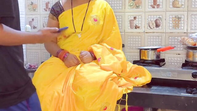 Indian hot stepmom in yellow saree caught by stepson in kitchen