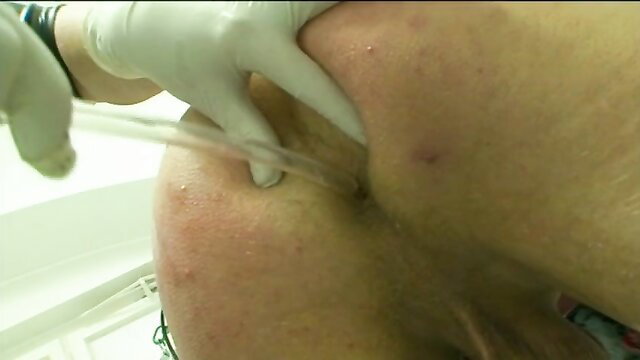 Die Gummi-Klinik Part 2: Rubber nurse catheterizing patient's urethra in BDSM clinic