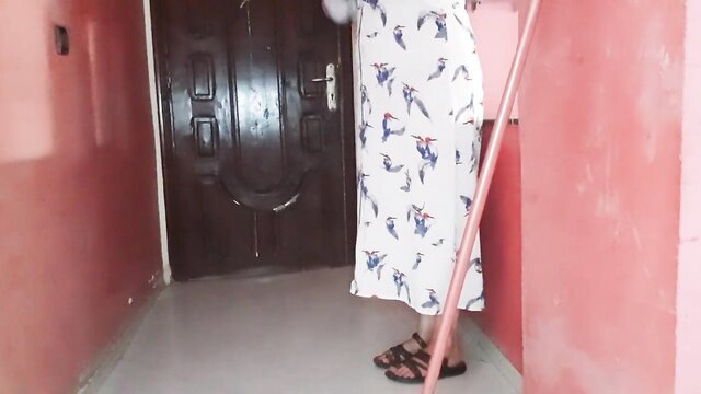 Beautiful Moroccan girl in floral dress stands by door in cuckold scene