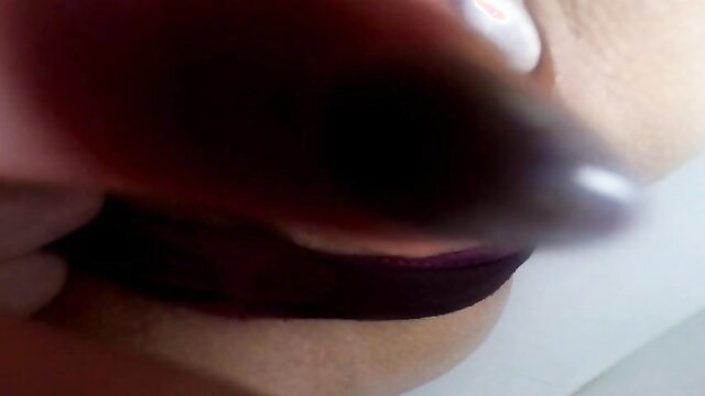 Closeup of woman's wet red panties pulled aside in solo tease