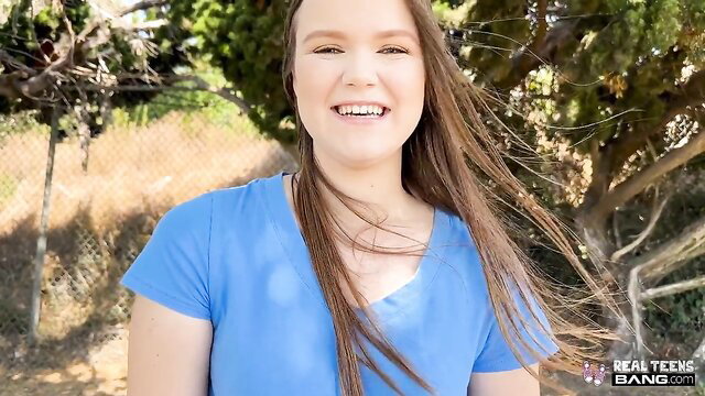 Smiling brunette teen in blue tank top outdoors, realteensbang