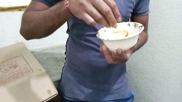 Couplefiree man eating yogurt from bowl in casual tee, hot kitchen tease