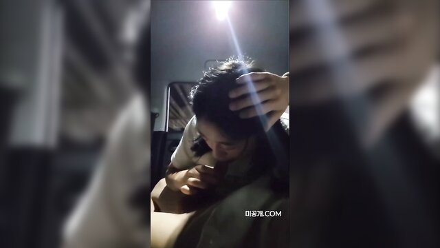 Korean amateur babe giving head in car, hand on head closeup
