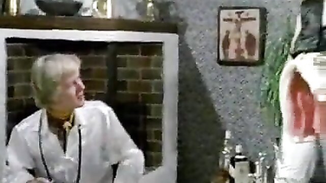 Blonde mature woman in white lab coat in classic 80s porn scene