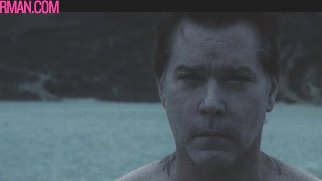 Tattooed bad boy celeb stares intensely wet on beach, Mr Man