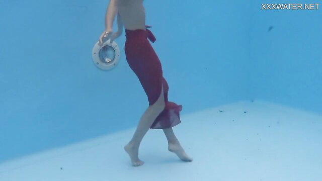 Hermione Ganger underwater in red skirt, nude legs, seductive pose