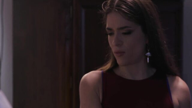 Seductive brunette in red dress pouts sultrily, softcore tease