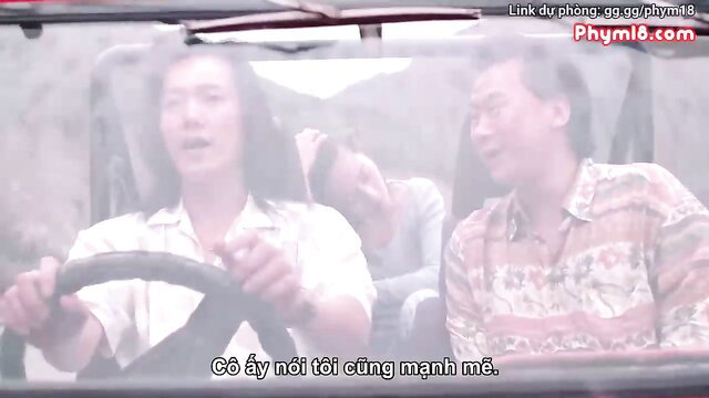 Vietnamese amateur couple in car, smiling woman driving with man