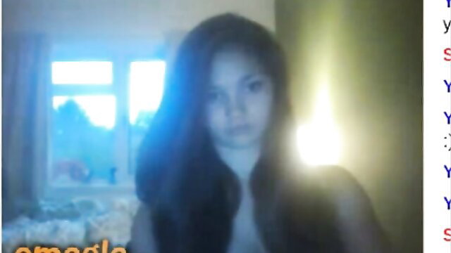 Blurry Asian Omegle slut in low-cut top smiling at webcam