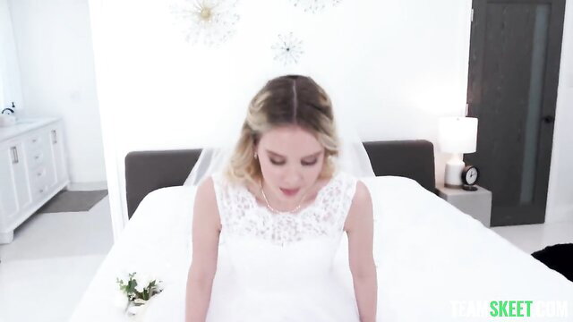 Blonde bride Ken Feels in lace wedding dress on bed, Team Skeet
