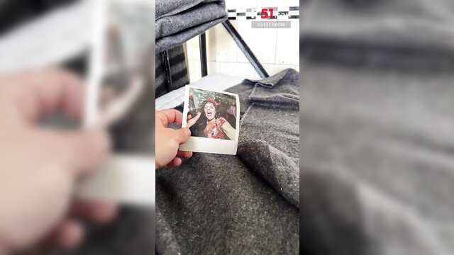 Hand holding Polaroid of smiling girl in extreme shower adult video thumbnail