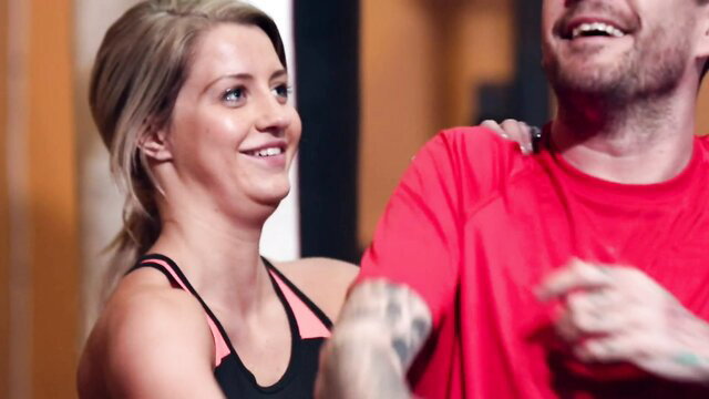 Sienna Day smiles playfully with tattooed guy in sporty gym wear