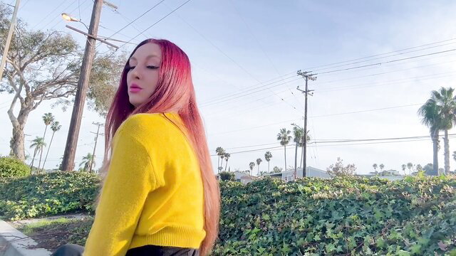Artemisia Love pink hair in yellow sweater outdoors LA palms
